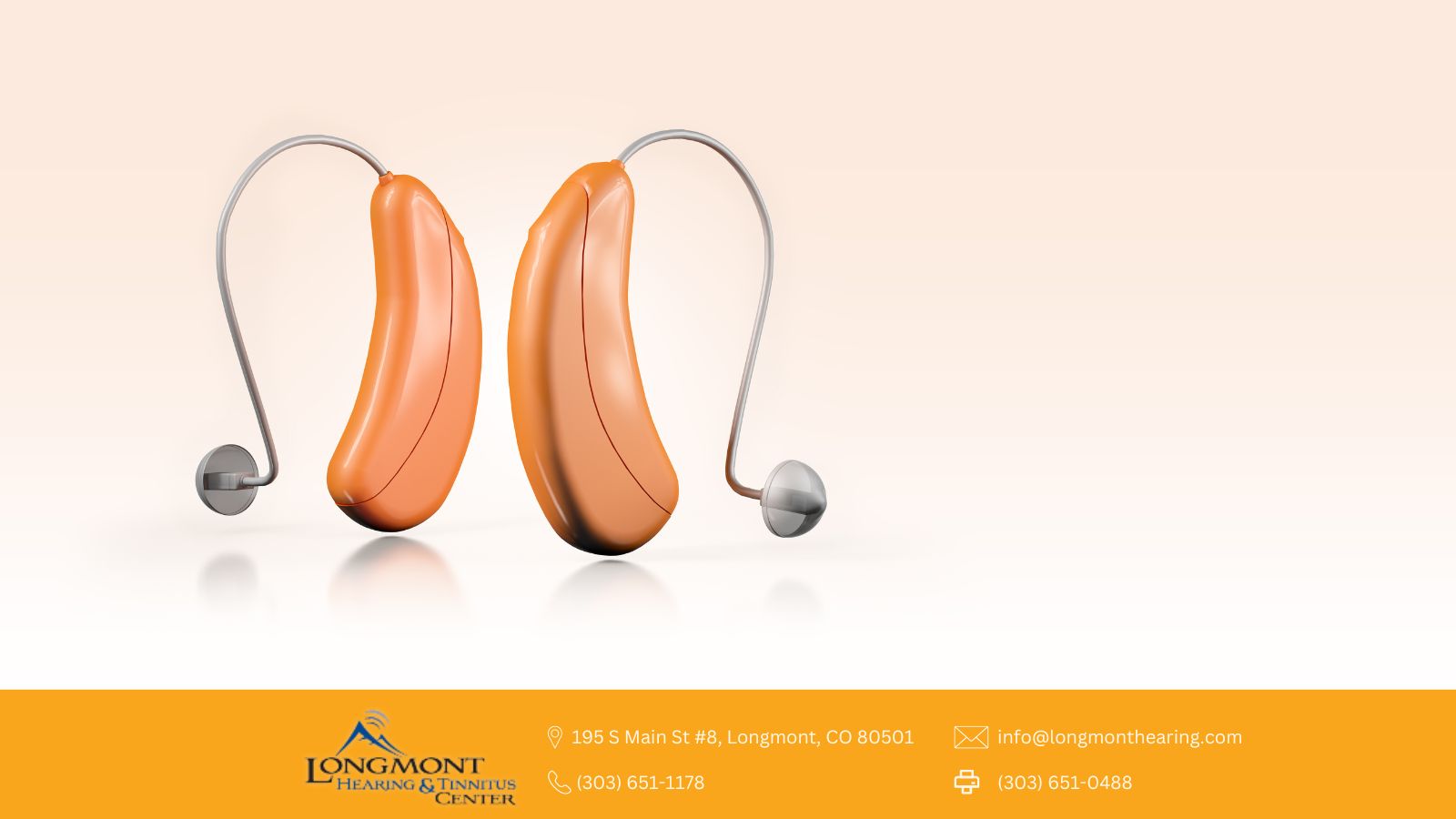 a pair of orange hearing aids